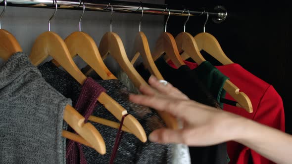 Woman Hand Choosing Dress in Wardrobe for Evening Dinner or Party alt