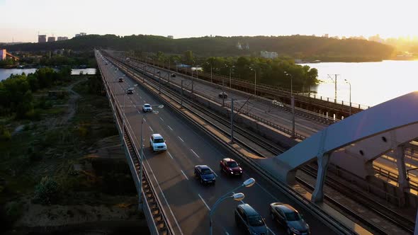 Aerial View of a Long City Bridge with Bright Sunlight alt