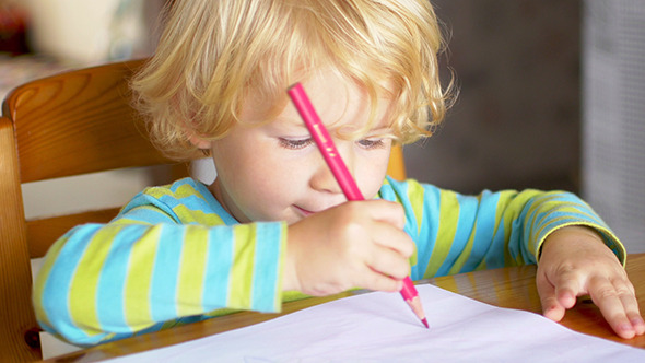 Cute Boy Drawing With Colourful Pencils