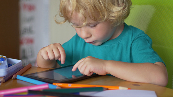 Portrait Of A Boy Using Touchscreen Tablet