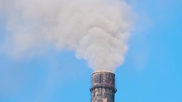Closeup of Thermal Power Plant High Pipes with Black Smoke Moving Upwards Polluting Atmosphere alt