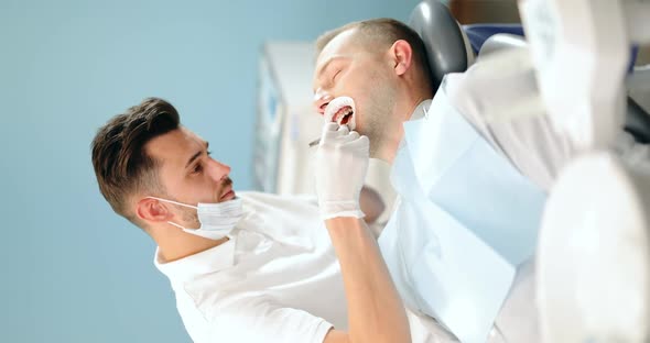 Dentist and Patient During an Orthodontic Treatment alt