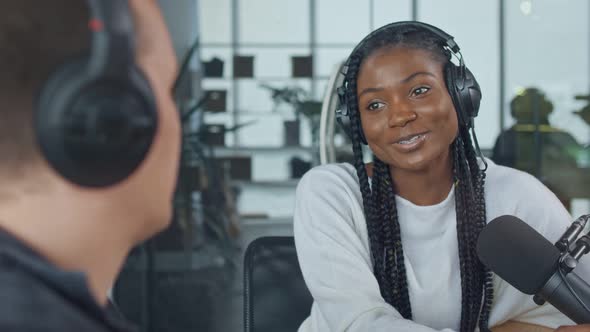 Two Young Men in a Recording Studio Create Audio Content Record a Podcast alt