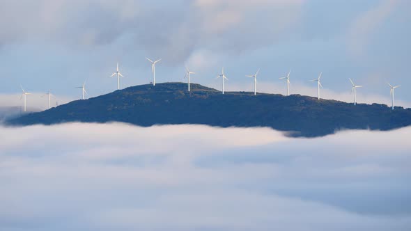Wind Turbines Farm above Clouds