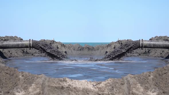 Mud Comes Out in Slow Motion From Two Pipes alt