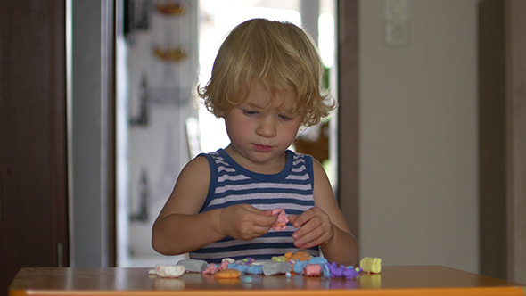 Boy Playing With Plasticine