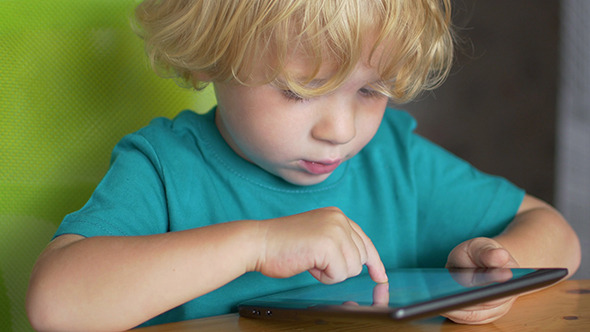 Little Boy Playing On The Tablet Computer Games