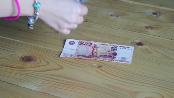 Counting Money On a Wooden Table