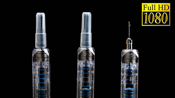 Three Glass Syringes Isolated on Black Background