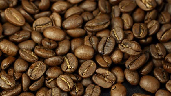 Rotation close-up of coffee beans 360. Golden selected aromatic beans rotates alt