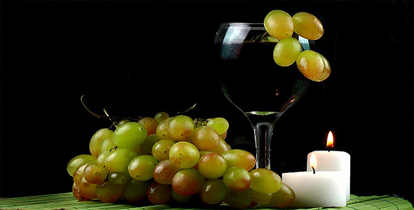 Glass of Wine and Grapes with Candles