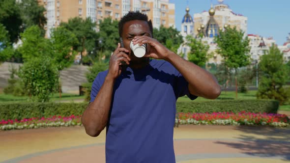 Portrait AfroAmerican Man Talking on Mobile Phone Drinking Coffee Tea in Summer alt