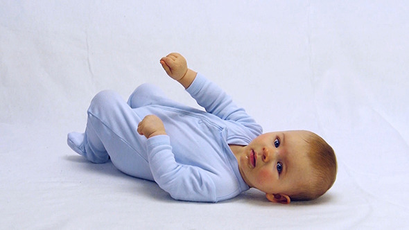Baby Boy Lying On A White Underground alt