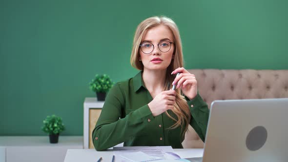 Adorable Business Young Woman in Glasses Posing at Modern Workplace alt