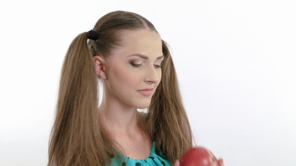 Attractive Model Eating An Red Apple On White alt