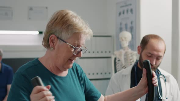 Senior Patient Doing Recovery Procedure on Stationary Bicycle alt