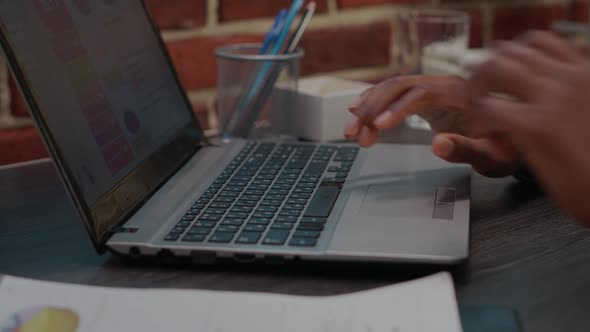 Office Worker Using Laptop to Work on Company Innovation alt