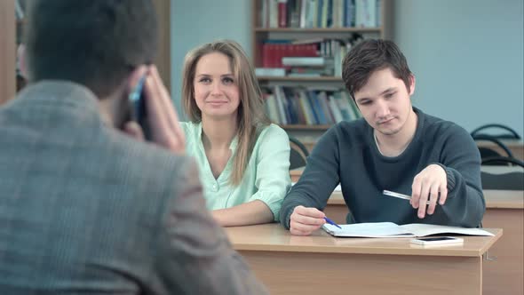 Group of University Students Sitting at Their Desks in Auditorium and Waiting for Teacher, While He alt