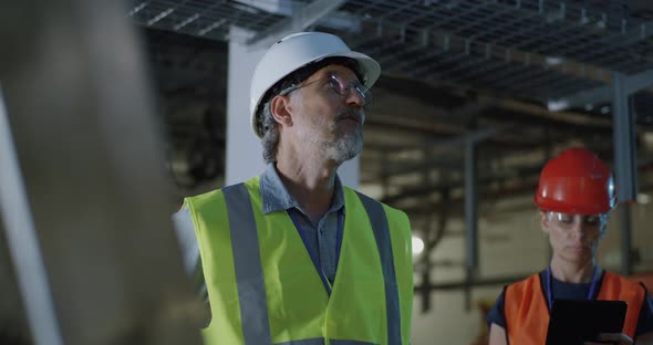 Engineer Talking To Assistant During Power Plant Inspection alt