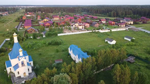 Drone flying over village with church