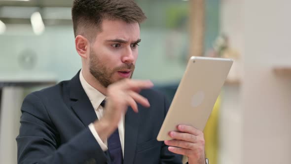 Disappointed Young Businessman Having Loss on Tablet, Failure  alt
