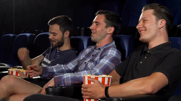 Group of Male Friends Watching Movies Together at the Cinema alt