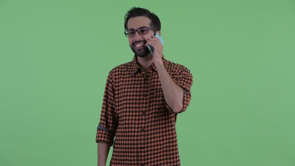 Happy Young Bearded Persian Hipster Man Thinking and Talking on the Phone alt