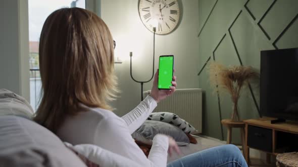 Woman at Living Room Use Smartphone for Video Call alt