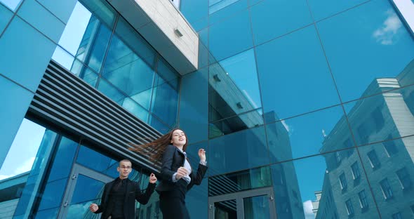 Colleagues, Students Wear Classic Suits, Dance Celebrate Outdoor, Against Backdrop of Blue Glass alt