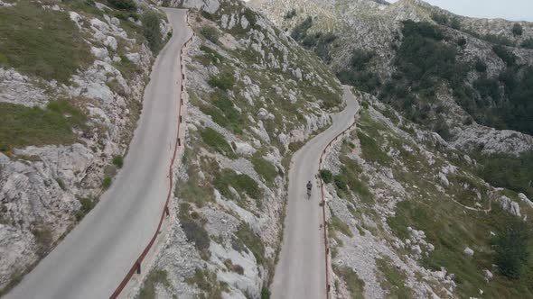 The Cyclist is Moving on a Narrow and Dangerous Mountain Road Located in Biokovo Park in Croatia