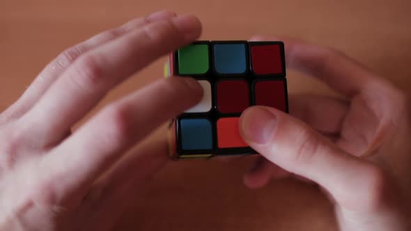Rubik's Cube in the Hands of a Man Close Up