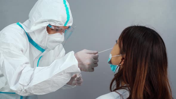 doctor with PPE suit test coronavirus(covid-19) to patient by nasal swab alt