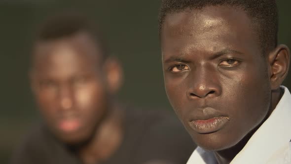 black pride. Two serious young African men stare at the camera - change of focus alt