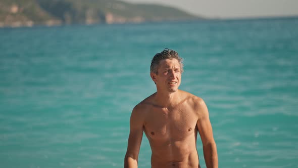 Slow Motion of Enjoyed Athletic Man Going Out of Turquoise Water of Mediterranean Sea in Oludeniz alt