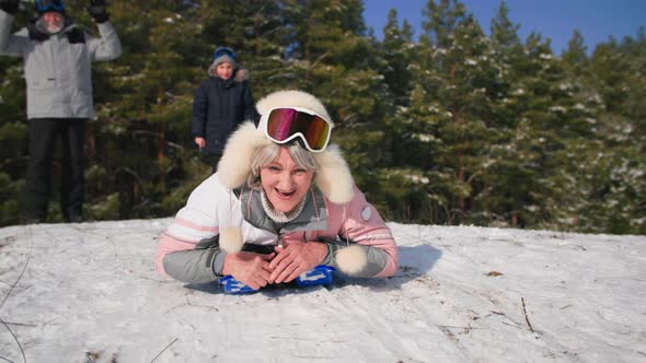 Entertainment for Elderly a Joyful Old Woman Leads an Active Lifestyle and Sledding From a Snowy