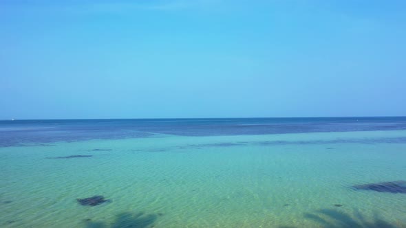 Daytime overhead abstract shot of a white sand paradise beach and turquoise sea background alt