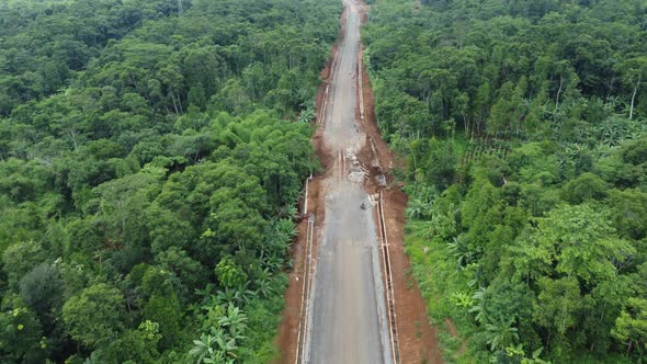 Land clearing for the highway from aerial drone footage of forward motion alt