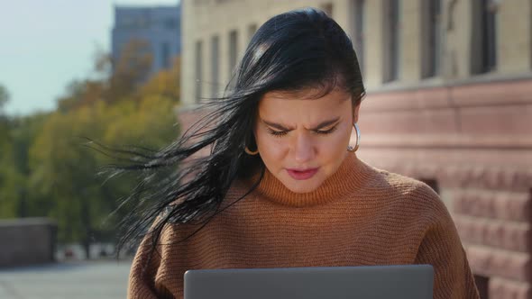 Closeup Young Focused Serious Woman Working on Laptop Reading Bad News Looks Desperate Feels Sad alt