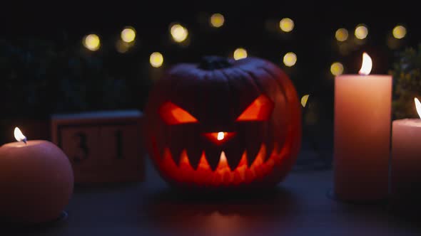 Smiling Halloween Pumpkin on the Wooden Table in a Mystic Night alt