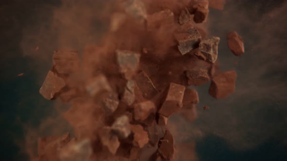 Super Slow Motion Shot of Flying Raw Chocolate Chunks and Cocoa Powder at 1000 Fps alt