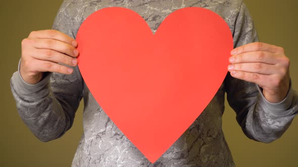 Man with Big Red Paper Heart As Sign of Love