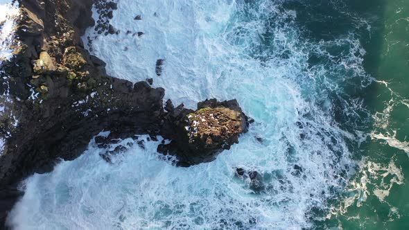 Drone Captures the Majestic Icelandic Ocean Waves Upwards from a Top Down View alt