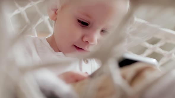 Kid in Wicker Chair Using Smartphone