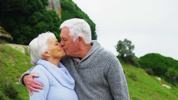 Senior man kissing senior woman alt