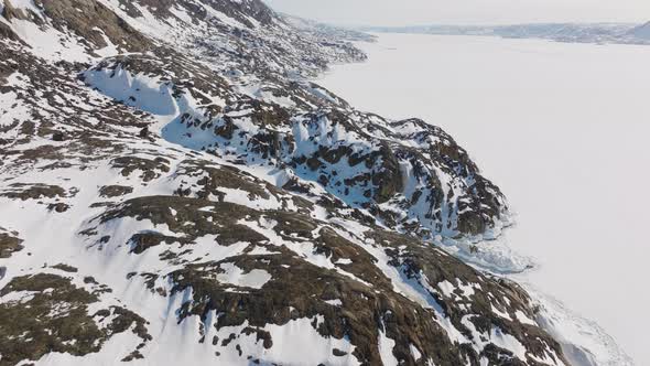 Drone Flight Over Snow Covered Rocks And Ice Of Sissiiut alt