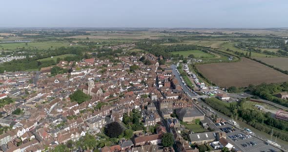 Slow pan above Sandwich Village in Kent, looking down the river alt