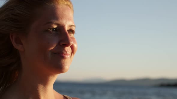 Woman enjoying sea climate on the beach 4K 2160p 30fps UltraHD footage - Beautiful scene with blond 