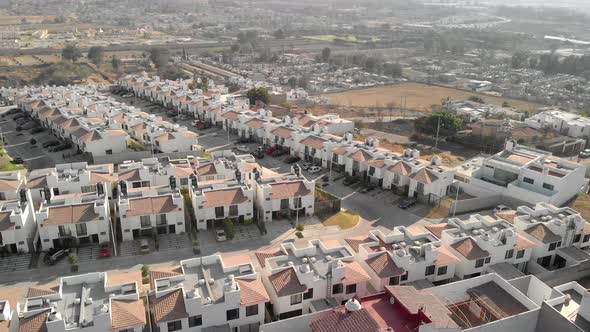 Aerial view of house buildings with street in a residential area at Alta California, Mexico - drone alt