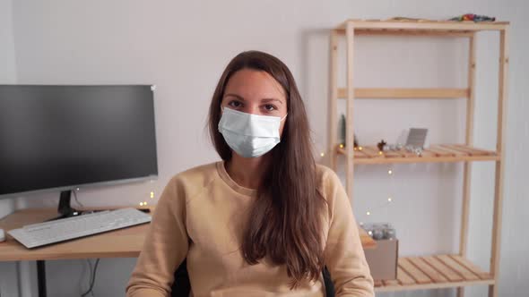 Young Woman in Office Put Off Medical Mask. End of Quarantine Vaccine Covid-19 alt