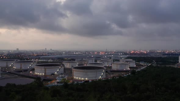 Aerial view drone flying with light oil terminal is industrial facility for storage of oil.